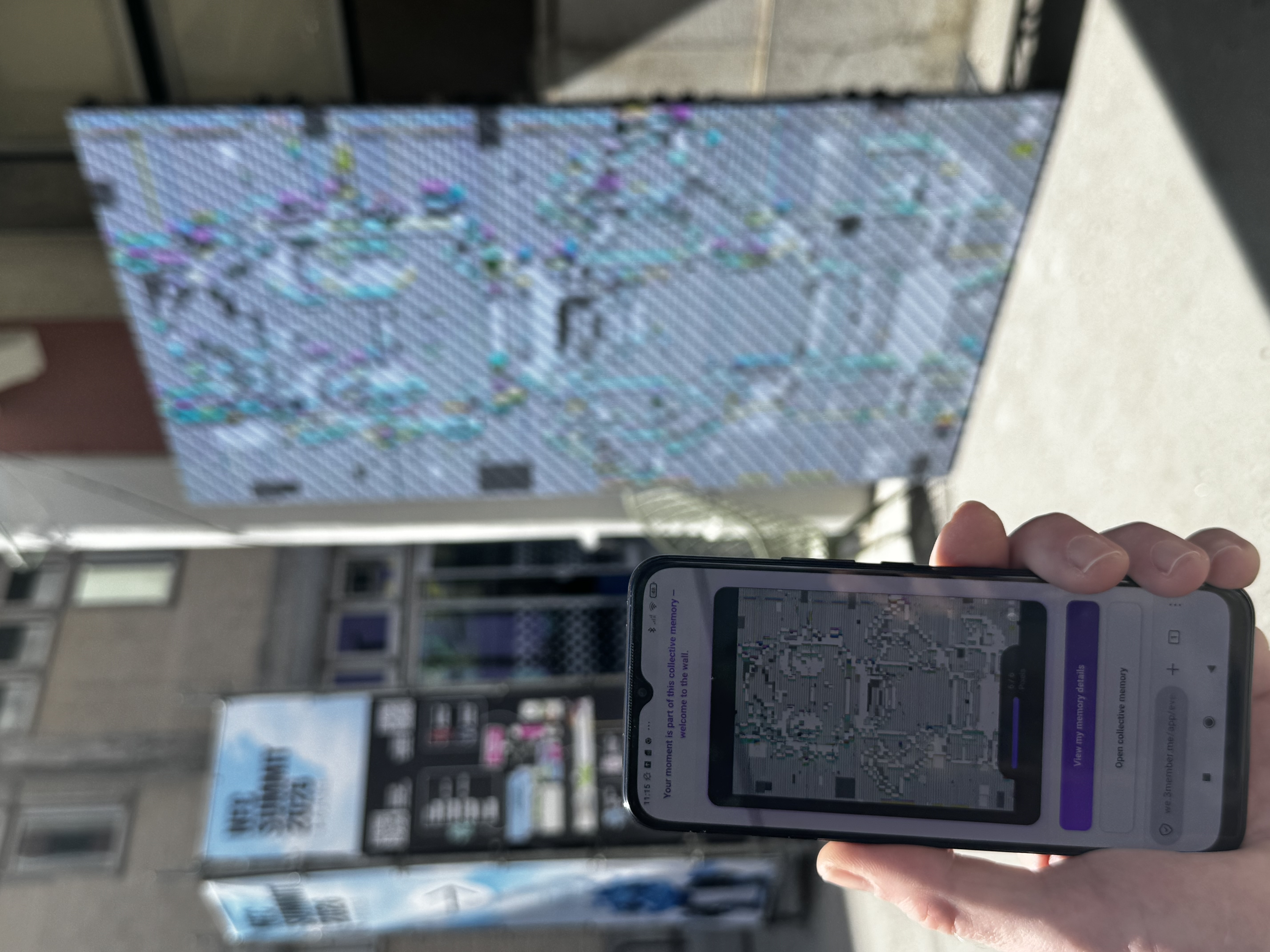 Live collective wall at NFC Summit — phone in hand